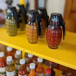 a shelf of hot sauces and condiments