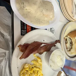 Scrambled eggs, grits, bacon and 1 sausage gravy biscuit.