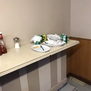 a counter with plates and cups on it