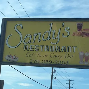 a sign for sandy&apos;s restaurant