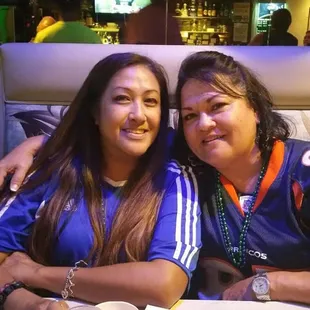 Here is one of our bartenders Mari and one of our regulars enjoying everyone&apos;s company from the party