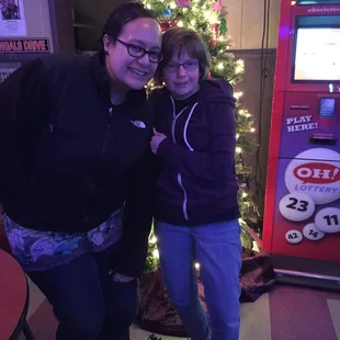 two women standing in front of a vending machine