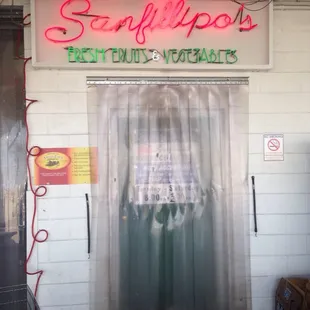 a storefront with a neon sign