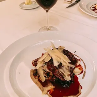 a plate of food and a glass of wine