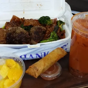 Thai iced tea with bubbles, beef egg roll, mango sticky rice, and lamb/beef drunken noodles.