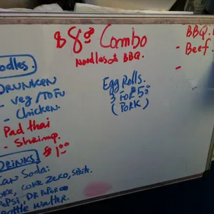 a whiteboard with a price list on it