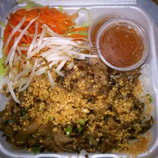 Beef with vermicelli noodles. Delicious! W/ crunchy bean sprouts, pickled carrot, crushed peanuts, and a sweet chili/fish sauce