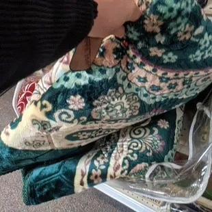 a person holding a pair of slippers