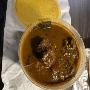 a bowl of soup and a tortilla