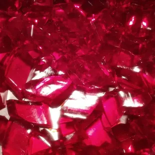a close up of a pile of red glass shards