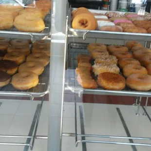 a variety of donuts in a display case