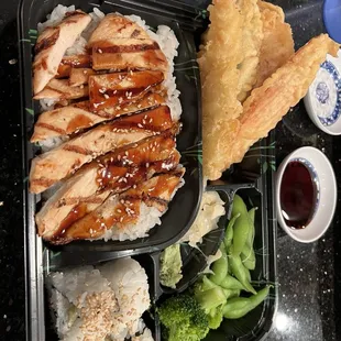 Oriental bento with teriyaki chicken, tempura, edamame, California roll, and a side of poke salad