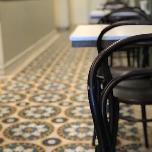 Pretty tile floors and small white tables for 2 only.