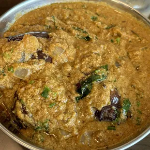 GUTTI VANKAYA KOORA: Eggplant stuffed with a masala blend, simmered in aromatic spices and tamarind sauce.