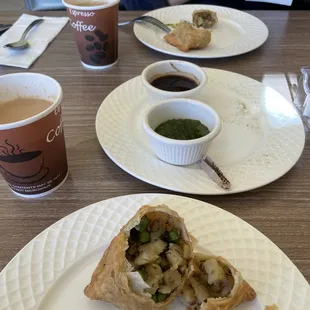 Samosas with sweet and savory sauces.