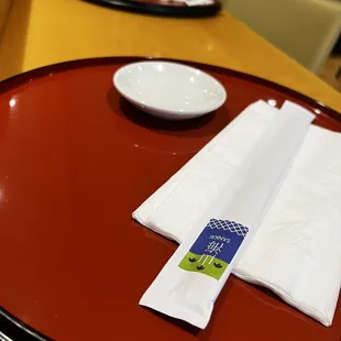a place setting with napkins and bowls