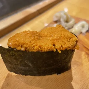 a piece of sushi on a cutting board