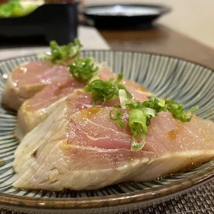 two pieces of raw fish on a plate