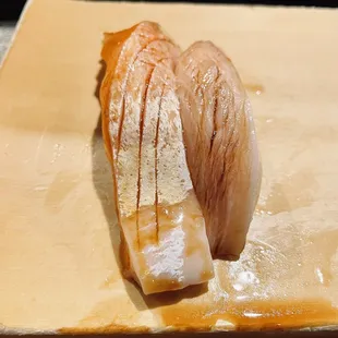 two pieces of fish on a cutting board