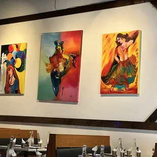 three paintings on the wall