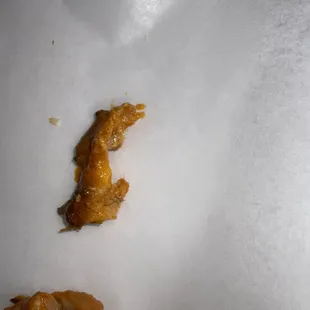 More fat globs on a tiny piece of chicken