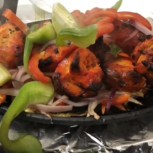 Grill tandoori chicken on hot plate. Meat is a bit dry.
