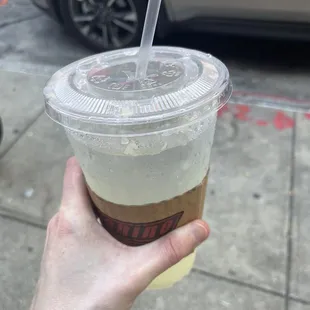 a hand holding a cup of coffee