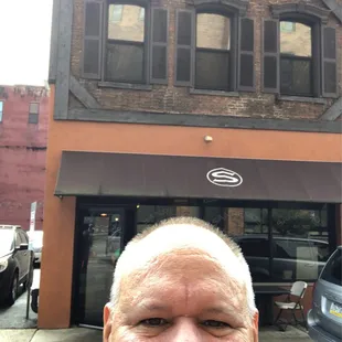 a man in front of a building