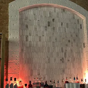 bottles of liquor lined up on a bar
