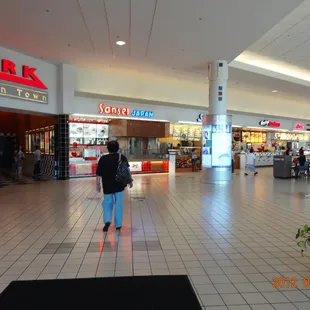 a woman walking through a mall