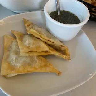 a bowl of soup and pita chips