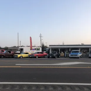 Classic cars parked in front of taco truck, nice!