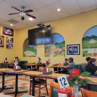 people sitting at tables and eating