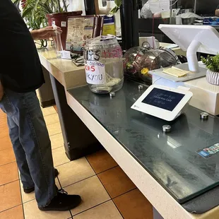 a man standing at a counter with a tablet