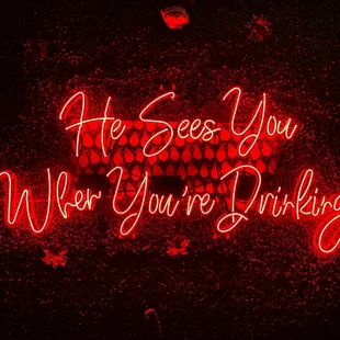 a neon sign that says he sees you when you're doing