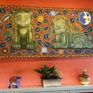 a painting of a cat and a lion
