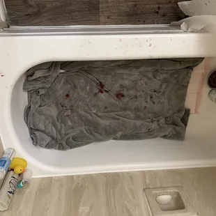 The bloody bath tub where he was laying