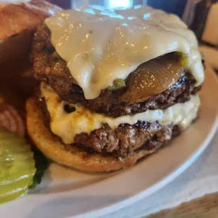 Double green chile cheese burger with grilled onions.
