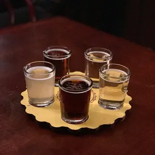 four glasses of beer on a tray