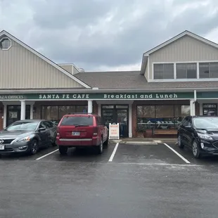 three cars parked in front of the restaurant