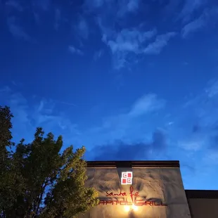 a restaurant sign lit up at night