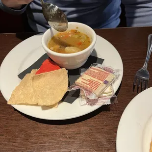 Green chili soup with chips and saltines