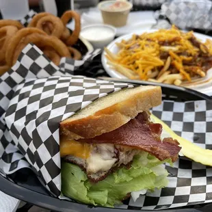 Bacon burger on sourdough, chili fries and onion rings