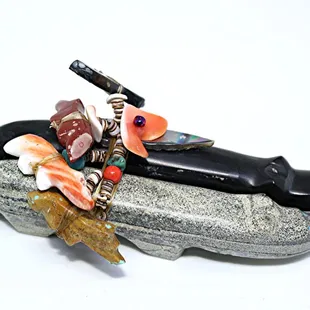 Offering a variety of Zuni  fetishes. Wolf family by Jayne Quam.