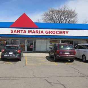 several cars parked in front of a store