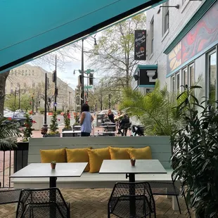 a view of a patio with tables and chairs