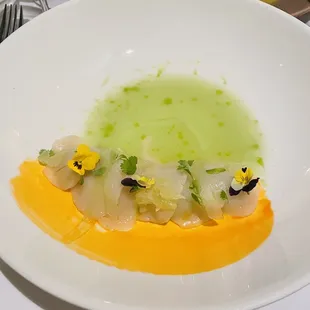 Scallop Sashimi in a Cucumber &amp; Farro sauce. Topped over avocado and lime.