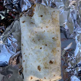 a burrito wrapped in aluminum foil