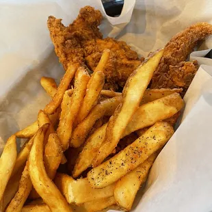 a basket of fried chicken and french fries