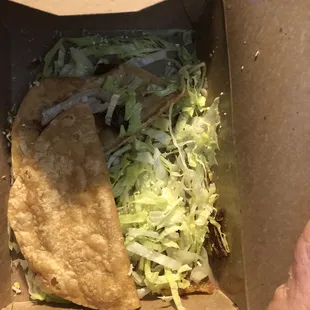 One shredded beef taco. Missing beef, cheese, and requested sour cream.